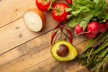 Fresh set of vegetables on a wooden background with space. Colorful background. Vegetarian sets. Harvest. Gastronomy