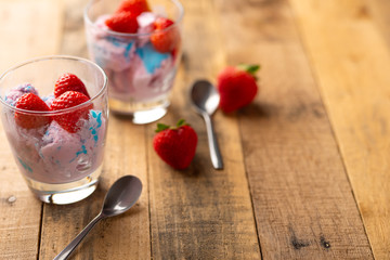 Ice cream with strawberries on wooden background.Flat lay.Summer mood