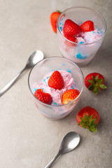 Ice cream with strawberries in transparent glasses. Vertical photo. Summer mood
