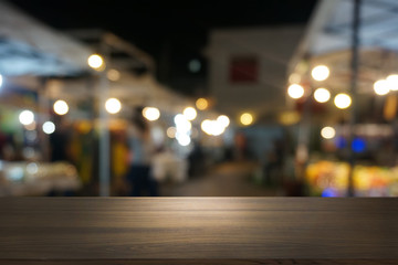 Empty dark wooden table in front of abstract blurred bokeh background of restaurant . can be used for display or montage your products.Mock up for space.