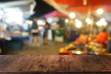 Empty dark wooden table in front of abstract blurred bokeh background of restaurant . can be used for display or montage your products.Mock up for space.