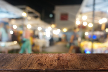 Empty dark wooden table in front of abstract blurred bokeh background of restaurant . can be used for display or montage your products.Mock up for space.