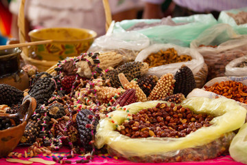 several kind and variations of mexican corn on a wood table, peanuts,