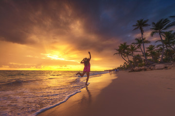 Free happy woman enjoying tropical Caribbean island beach, Dominican Republic. Summer vacation and...
