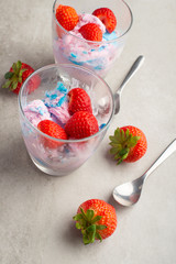 Ice cream with strawberries in transparent glasses. Vertical photo. Summer mood