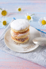Curd cheesecakes on a white plate sprinkled with powdered sugar. Delicious dessert.