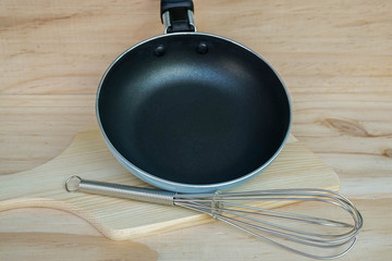 close up cute pan and egg breaker on wooden background for kitchenware