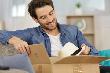 man receiving parcel at home