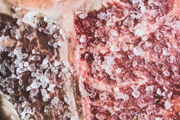 Raw fresh marble T-bone meat on the rustic background. Selective focus. Shallow depth of field.