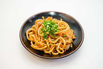 Plate of fried noodle with pork meat on white background | Asian Spaghetti
