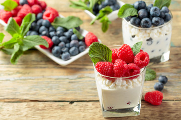 Cottage cheese with cream, raspberry and blueberry garnished with fresh mint.