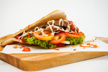 Doner Kebab side view on chopping board on white background