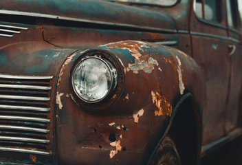 Rusty retro car with corrosion of body and cracked painting