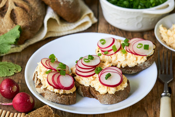 Sandwiches with boiled grated eggs and fresh radish