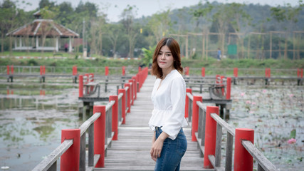 The girl standing on the red bridge