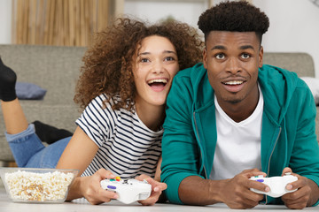 happy excited young couple playing videogames