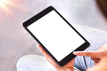 The woman's hand is holding the tablet in his hand. The tablet has a white screen.