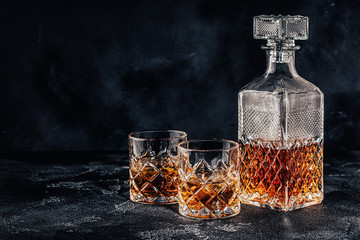 Glasses of the whiskey with a square decanter