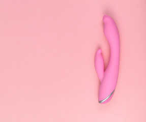 Beautiful evenly lit pink dildo on a glamorous background with copy space.