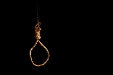 Fototapeta na wymiar Loop of braided rope on a gloomy dark background, failure or suicide concept