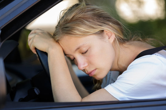 tired woman sleep in car