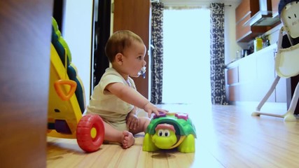 static shot, cute seven months old baby boy playing with educational toys on the floor happy childhood,early development concept