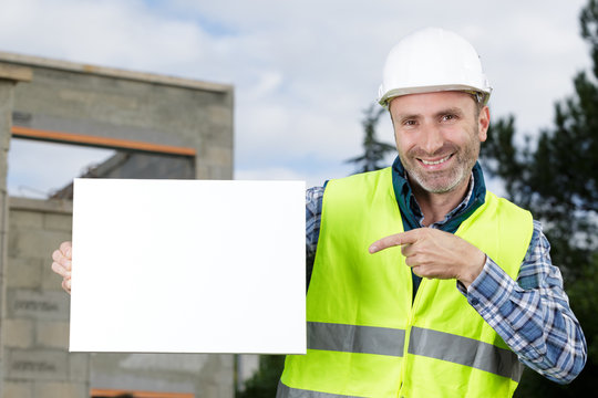happy worker presenting empty banner