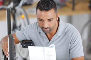 Fototapeta premium man working in bike workshop