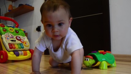 cute seven months old baby boy learning crawling,dolly out shot