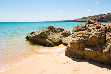 Fototapeta na wymiar Rocks on sandy Praia do Amado beach, Portugal