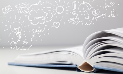 Open book on old wooden table.