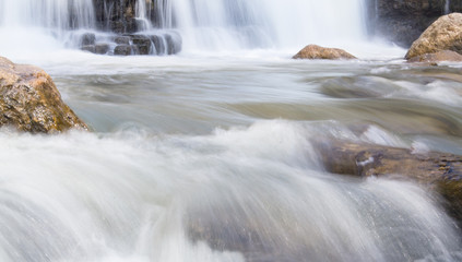 The waterfall with a rocks. Summer time