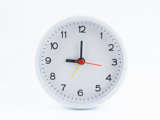 White alarm clock on white background, At nine o'clock in the morning, At three o'clock at night, The short needle is at the nine numbers and the needle is twelve numbers.