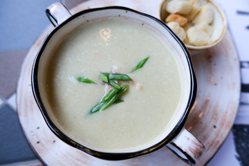Potato cream soup with fish and crackers and onions. Food for lunch.