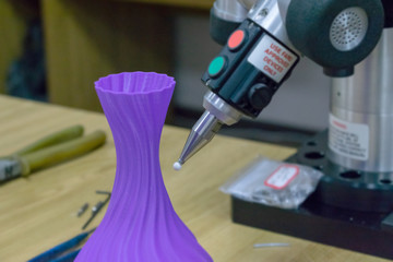 3D Measurements device measures 3D printed plastic part. 3D scan measurement workpiece. 3D measurement solutions for manual and automated inspection of part, component