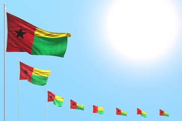 cute any feast flag 3d illustration. - many Guinea-Bissau flags placed diagonal on blue sky with space for content