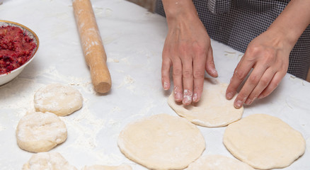 The hostess prepares the pies in the kitchen