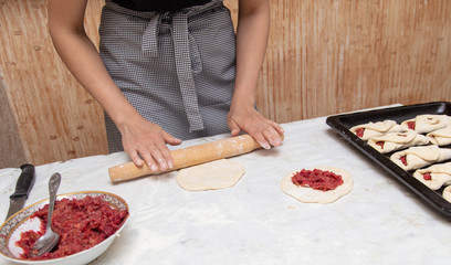 The hostess prepares the pies in the kitchen