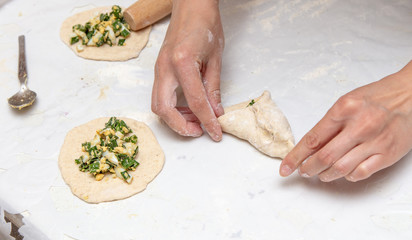 The hostess prepares the pies in the kitchen