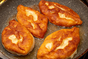 Patties are fried in oil in a pan