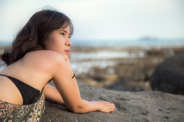 Fototapeta na wymiar Portrait of Beautiful Asian woman smiling relaxing on summer beach.