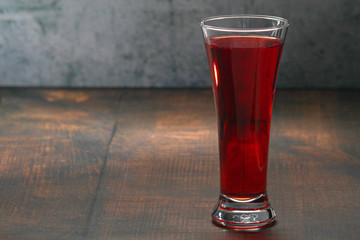 Red juicy drink in a high beer glass