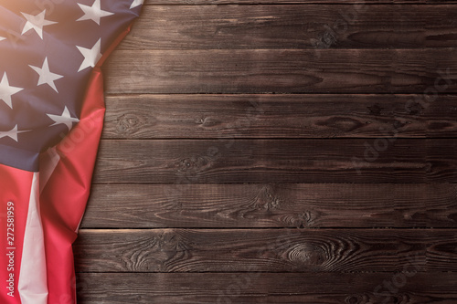 USA flag sideways on an empty wooden background