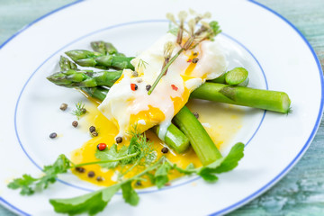 Fish fillet with asparagus curry sauce.blue wooden background