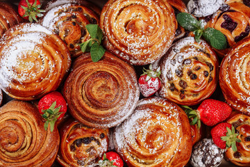 Cinnamon Raisin Bun Sweet Roll Pastry Flat Lay. Danish Bakery Cake with Strawberry and Sugar Powder Top Down View. Swirl Baked Bread Dessert Delicious Breakfast. Abstract Spiral Dough