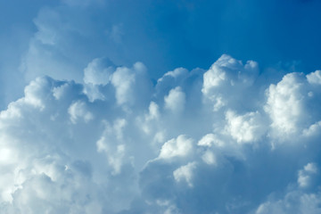 Blue sky background with white clouds.
