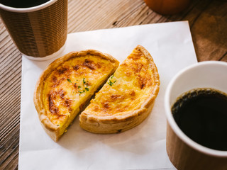Quiche with hot coffee Cafe table top view Hipster lifestyle Cafe culture