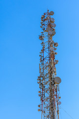 Telecommunication tower with the antennas or wireless Communication antenna transmitter against blue sky