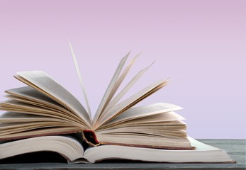 Stack of colorful books on  background