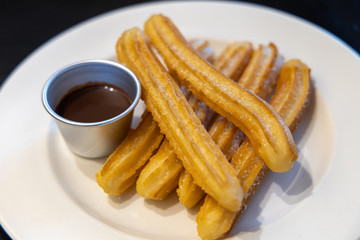 fried-dough pastry—predominantly choux—based snack churros with Chocolate Syrup